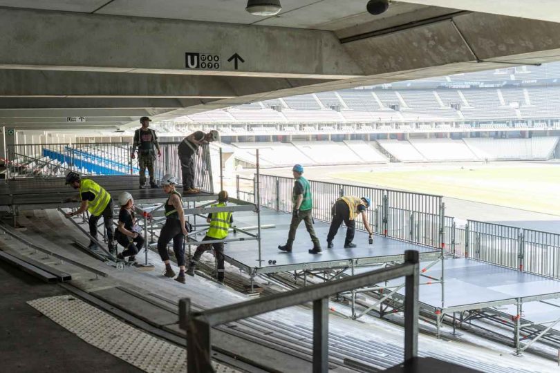 Radnici postavljaju montažni podest na tribinama stadiona